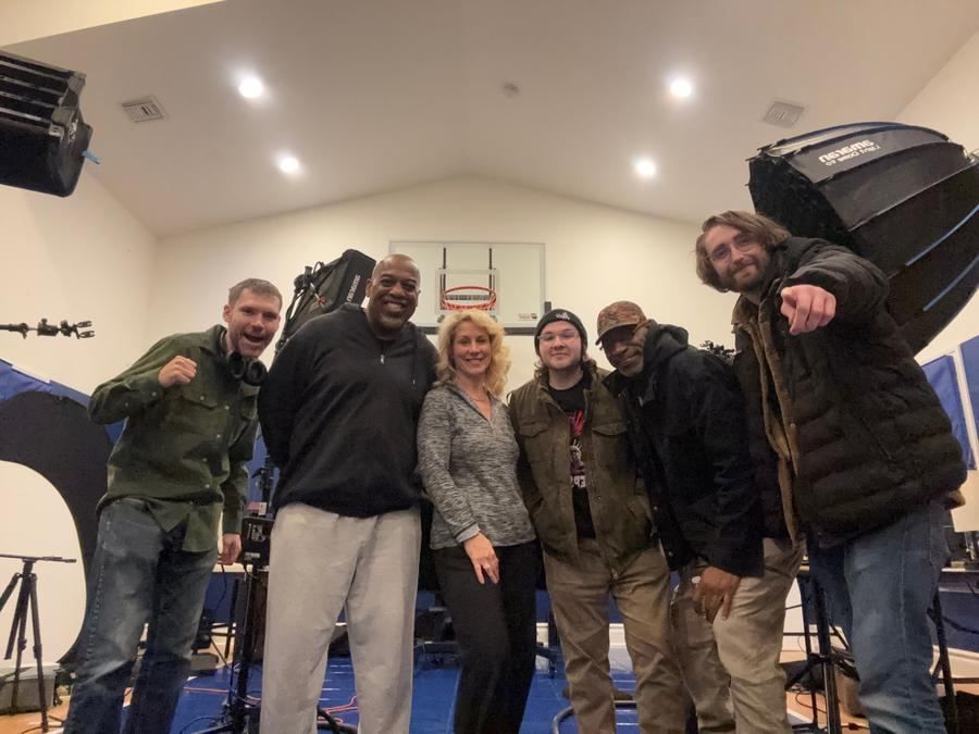 Production Team — Cast and crew on a practical studio set.